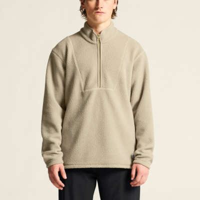 Craft Core Essence Tee men’s sport shirt in gray, shown on a model with a beige half-zip collar and long sleeves.